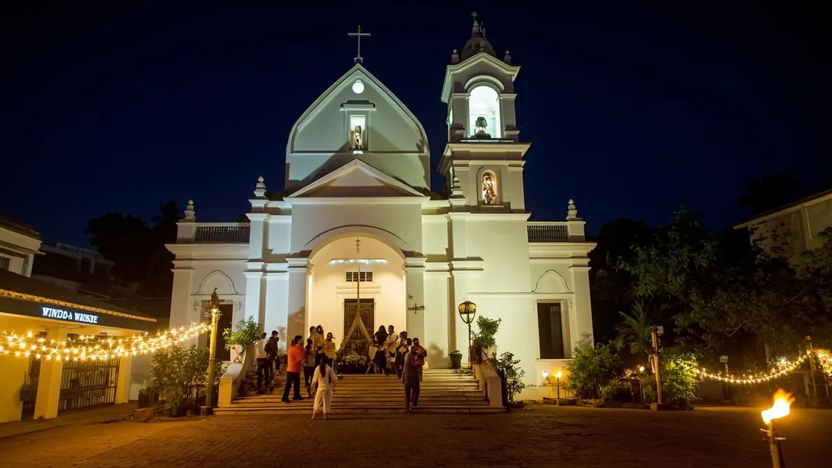 Immaculate Conception Cathedral lit up at night during Christmas Eve Mass in Pondicherry, with worshippers gathered outside.
